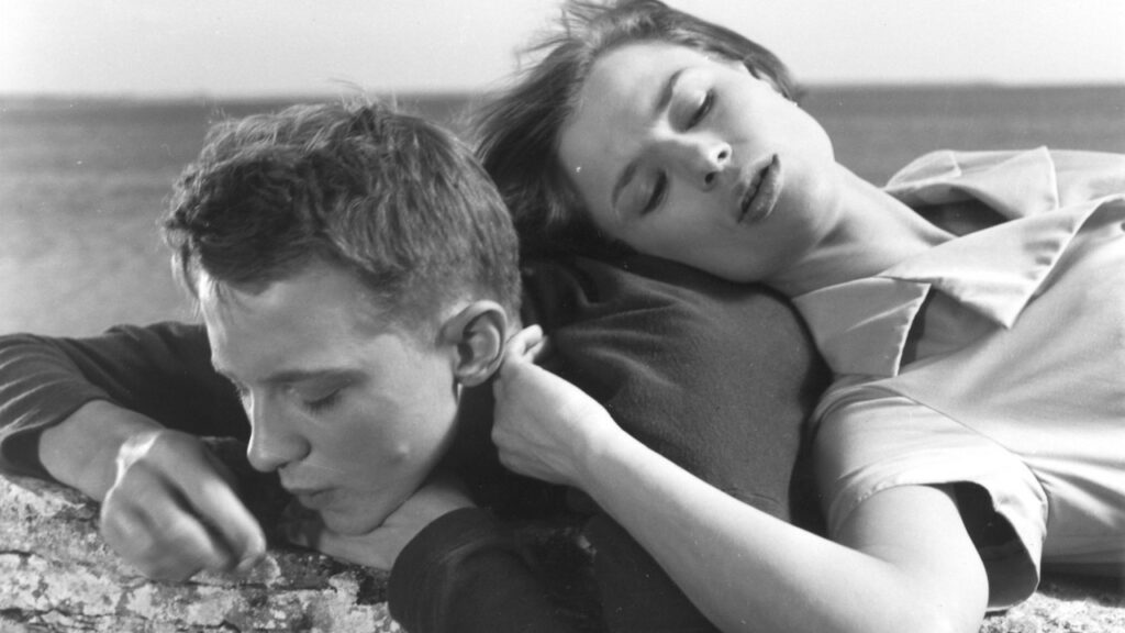A woman lying on top of a man